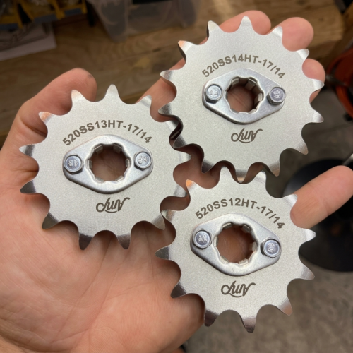 Amp QS 138 V3 520 tuning pack sprockets held in hand for scale
